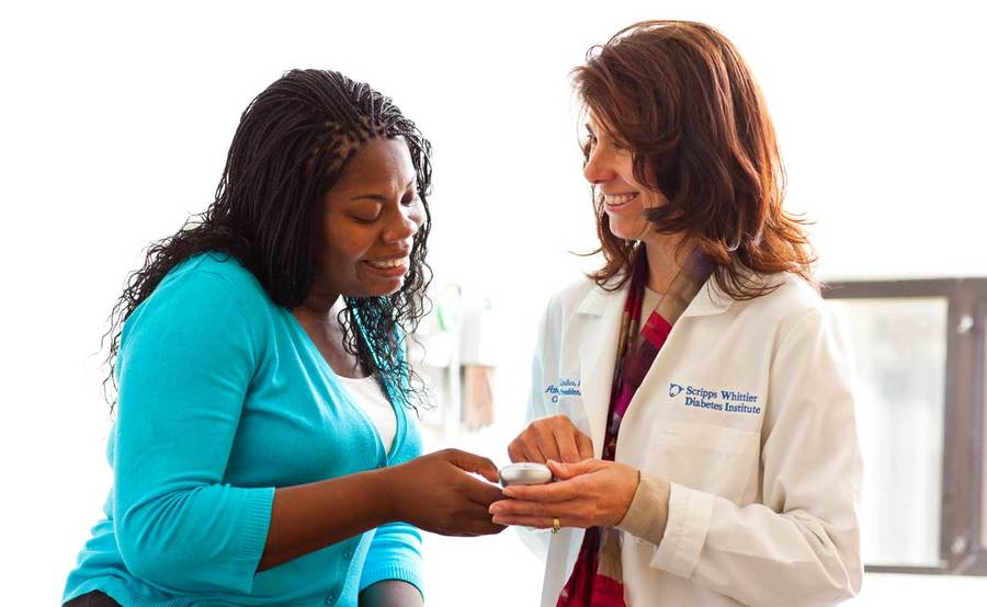 Dr. Athena Philis-Tsimikas, Endocrinology, Scripps Clinic, talks with a patient as part of a clinical study.
